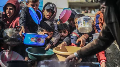 FILED - 31 December 2023, Palestinian Territories, Rafah: Palestinian children receive food prepared in a charity kitchen. Photo: Mohammed Talatene/dpa