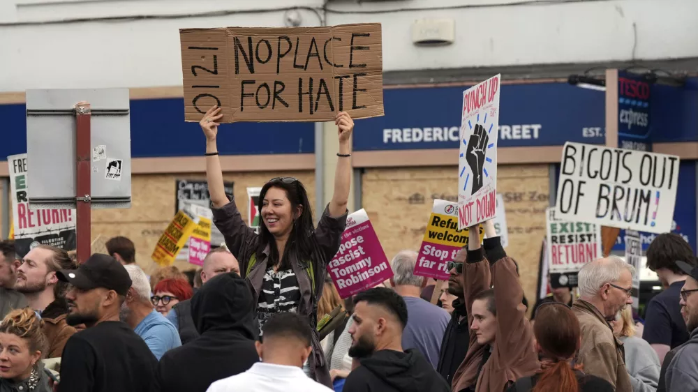 Counter protesters gather ahead of an anti-immigration protest in Birmingham, England, Wednesday, Aug., 7, 2024. (PA via AP)