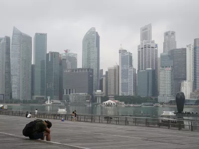 FILE - A man takes a nap as the central business district is shrouded by haze in Singapore, on Sept. 23, 2019. Singapore executed a man Wednesday, July 26, 2023, for drug trafficking and is set to hang a woman Friday — the first in 19 years — prompting renewed calls for a halt to capital punishment. (AP Photo/Vincent Thian, File)