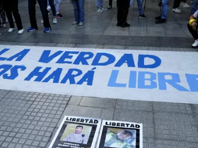 Demonstrators stand by a banner during a vigil in tribute to citizens who were detained, following disputed election results, in Caracas, Venezuela, August 8, 2024. REUTERS/Leonardo Fernandez Viloria