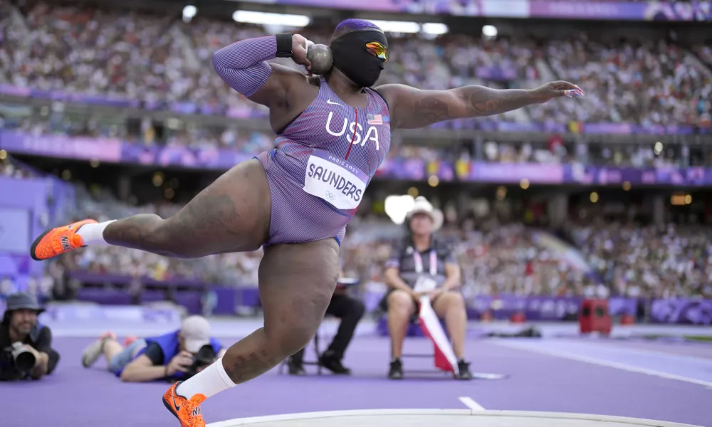 Raven Saunders, of the United States, competes during the women's shot put qualification at the 2024 Summer Olympics, Thursday, Aug. 8, 2024, in Saint-Denis, France. (AP Photo/Bernat Armangue)