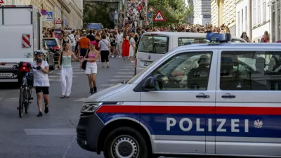 A police car stands near gathering swifties in Vienna on Friday, Aug.9, 2024. Organizers of three Taylor Swift concerts in the stadium in Vienna this week called them off on Wednesday after officials announced arrests over an apparent plot to launch an attack on an event in the Vienna area such as the concerts. (AP Photo/Heinz-Peter Bader)