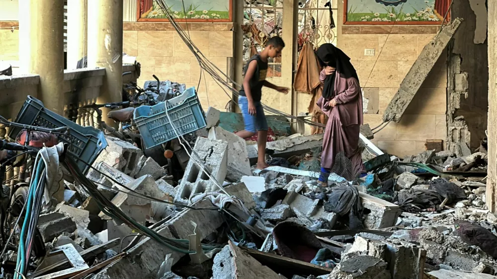 Palestinians inspect the site of an Israeli strike on a school sheltering displaced people, amid the Israel-Hamas conflict, in Gaza City, August 10, 2024. REUTERS/Abed Sabah