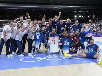 The French team pose for a photo after winning a gold medal men's volleyball match against Poland at the 2024 Summer Olympics, Saturday, Aug. 10, 2024, in Paris, France. (AP Photo/Dolores Ochoa)