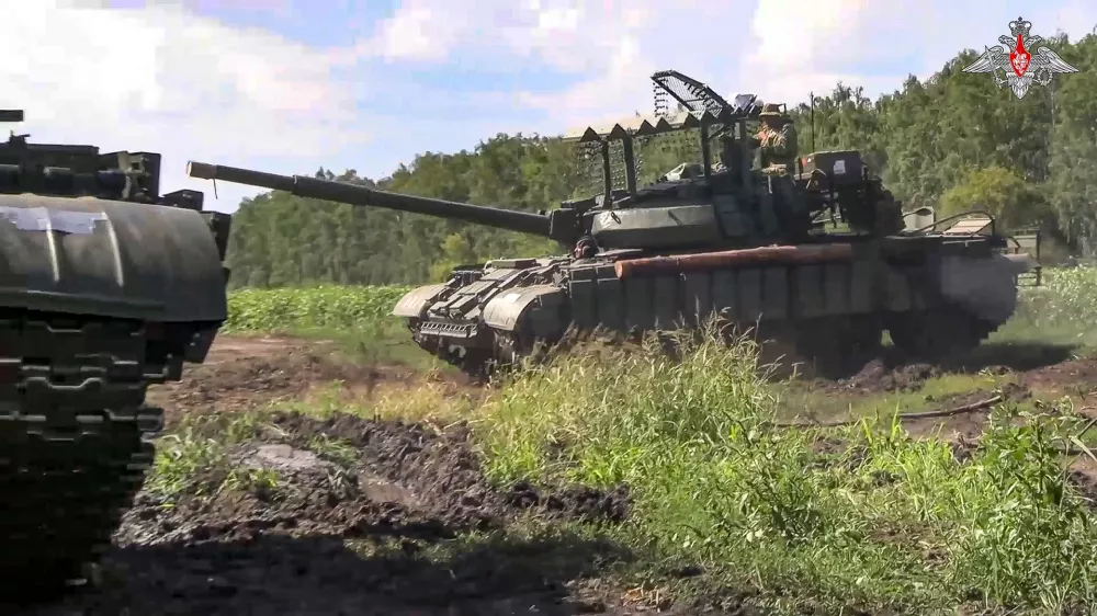 In this photo taken from video released by the Russian Defense Ministry on Saturday, Aug. 10, 2024, Russian Army tanks take a position at an area of ​​Kursk region of Russia. (Russian Defense Ministry Press Service via AP)