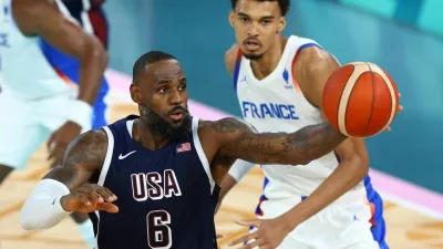 Paris 2024 Olympics - Basketball - Men's Gold Medal Game - France vs United States - Bercy Arena, Paris, France - August 10, 2024. Lebron James of United States in action with Victor Wembanyama of France. REUTERS/Stephanie Lecocq