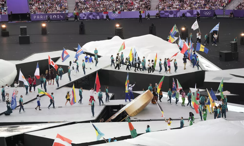 Athletes parade during the 2024 Summer Olympics closing ceremony at the Stade de France, Sunday, Aug. 11, 2024, in Saint-Denis, France. (AP Photo/Martin Meissner)