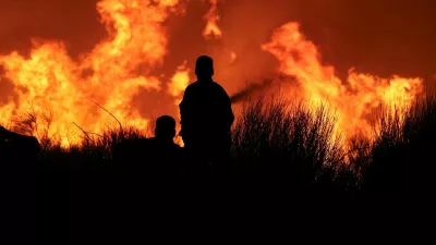 Firefighters try to extinguish a wildfire burning in Dionysos, Greece, August 12, 2024. REUTERS/Alexandros Avramidis