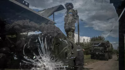 A Ukrainian serviceman repairs a military vehicle, amid Russia's attack on Ukraine, near the Russian border in Sumy region, Ukraine August 11, 2024. REUTERS/Viacheslav Ratynskyi