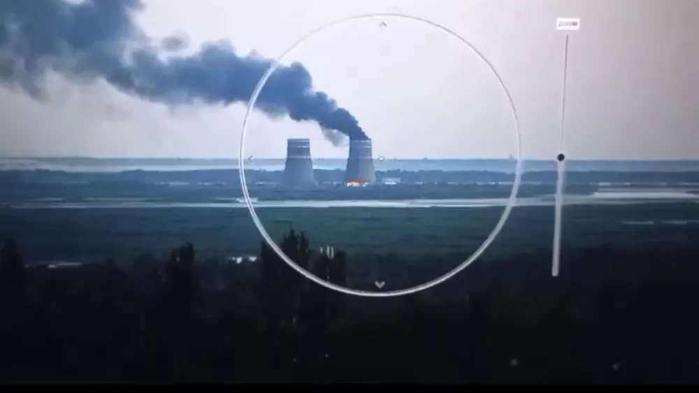 In this image from a surveillance camera provided by the Ukrainian Presidential Press Office, smoke rises from a cooling tower of the Zaporizhzhia Nuclear Power Station in a Russia-controlled area in the Energodar, Zaporizhzhia region of Ukraine, Sunday, Aug. 11, 2024. (Ukrainian Presidential Press Office via AP)