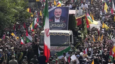 FILE - Iranians follow a truck, center, carrying the coffins of Hamas leader Ismail Haniyeh and his bodyguard during their funeral ceremony at Enqelab-e-Eslami (Islamic Revolution) Sq. in Tehran, Iran, Thursday, Aug. 1, 2024. (AP Photo/Vahid Salemi, File)