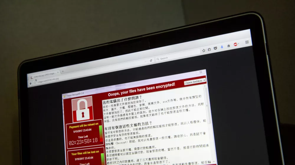 ﻿A screenshot of the warning screen from a purported ransomware attack, as captured by a computer user in Taiwan, is seen on laptop in Beijing, Saturday, May 13, 2017. Dozens of countries were hit with a huge cyberextortion attack Friday that locked up computers and held users' files for ransom at a multitude of hospitals, companies and government agencies. (AP Photo/Mark Schiefelbein)