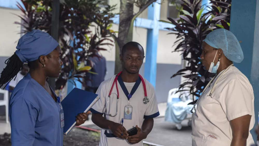 Medical staff talk to each other at the general hospital in Goma, Democratic Republic Of Congo, Wednesday, Aug. 14, 2024 after the World Health Organization declared the mpox outbreaks in Congo and elsewhere in Africa a global emergency. (AP Photo/Moses Sawasawa)