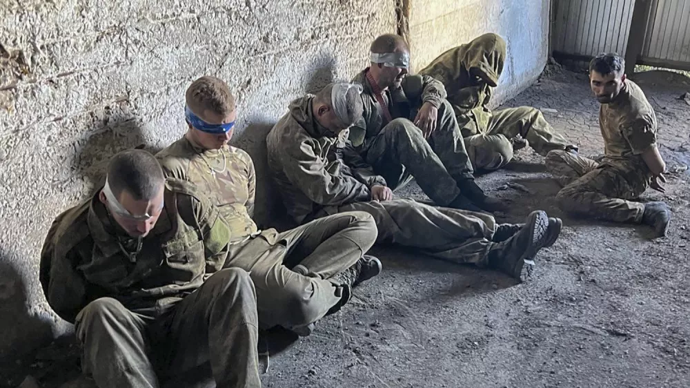 In this photo provided by the Ukrainian Security Service Press Office, over 100 Russian prisoners of war captured by a Security Service special unit during one military action are seen in a shelter in Kursk region, Russia, Wednesday, Aug. 14, 2024. (Ukrainian Security Service Press Office via AP)