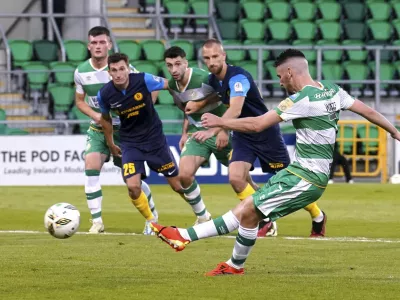 Shamrock Rovers' Dylan Watts scores their side's first goal of the game from the penalty spot, during the Europa League third qualifying round, 2nd leg soccer match against NK Celje, at Tallaght Stadium, in Dublin, Thursday, Aug. 15, 2024. (Brian Lawless/PA via AP)