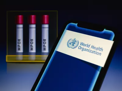 14 August 2024, Paraguay, Asunción: World Health Organization (WHO) logo is displayed on a smartphone in front of visual representation of test tubes labeled 'mpox'. WHO on 14 August 'has determined that the upsurge of mpox in the Democratic Republic of the Congo (DRC) and a growing number of countries in Africa constitutes a public health emergency of international concern (PHEIC) under the International Health Regulations (2005) (IHR).' Photo: Andre M. Chang/ZUMA Press Wire/dpa