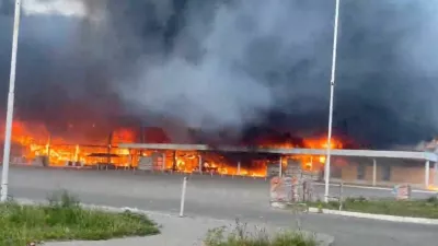 Smoke and flames rise from a shopping center damaged by shelling in the course of the Russia-Ukraine conflict, in Donetsk, Russian-controlled Ukraine, in this screengrab taken from a video released on August 16, 2024. Video Obtained by Reuters. THIS IMAGE HAS BEEN SUPPLIED BY A THIRD PARTY. NO RESALES. NO ARCHIVES.