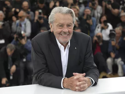 FILE - Actor Alain Delon poses for photographers at the photo call for his honorary Palme D'Or award at the 72nd international film festival, Cannes, southern France, Sunday, May 19, 2019. Alain Delon, the internationally acclaimed French actor who embodied both the bad guy and the policeman and made hearts throb around the world, has died at age 88, French media reported. (Photo by Vianney Le Caer/Invision/AP)