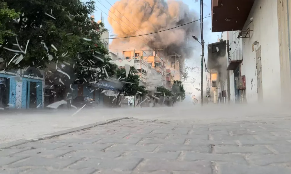 Smoke rises following an Israeli strike on a residential building, amid the ongoing conflict between Israel and Hamas, Nuseirat in the central Gaza Strip, in this screen grab taken from a video, August 18, 2024. Reuters TV via REUTERS