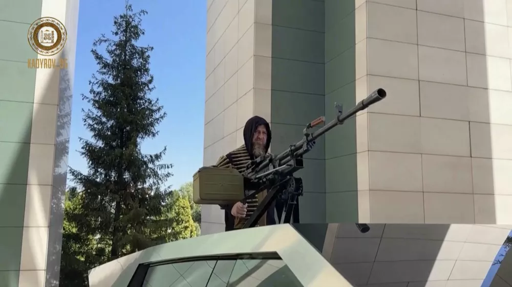 In this image from video posted by Chechen leader Ramzan Kadyrov's Telegram channel on Saturday, Aug. 17, 2024, Kadyrov stands with a machine gun mounted on a Tesla Cybertruck in Grozny, Chechnya. (Ramzan Kadyrov Telegram channel via AP)