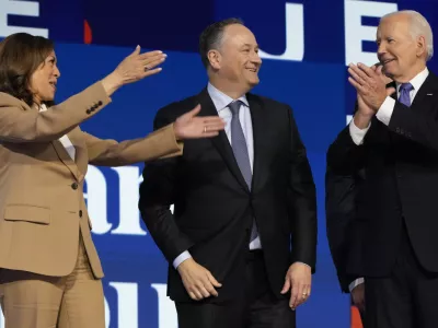 President Joe Biden greets Democratic presidential nominee Vice President Kamala Harris as second gentleman Doug Emhoff watches during the first day of Democratic National Convention, Monday, Aug. 19, 2024, in Chicago. (AP Photo/Jacquelyn Martin)