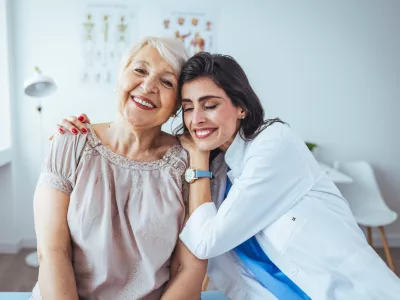 The elderly woman enjoys an embrace from her favorite home healthcare nurse. Medical care, young female doctor hugging patient. Empathy concept. Elderly woman hugging caregiver / Foto: Dragana991