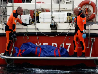 Rescue personnel transport a body bag containing the corpse of British entrepreneur Mike Lynch, who died when a yacht owned by his family sank off the coast of Porticello, near the Sicilian city of Palermo, Italy, August 22, 2024. REUTERS/Guglielmo Mangiapane