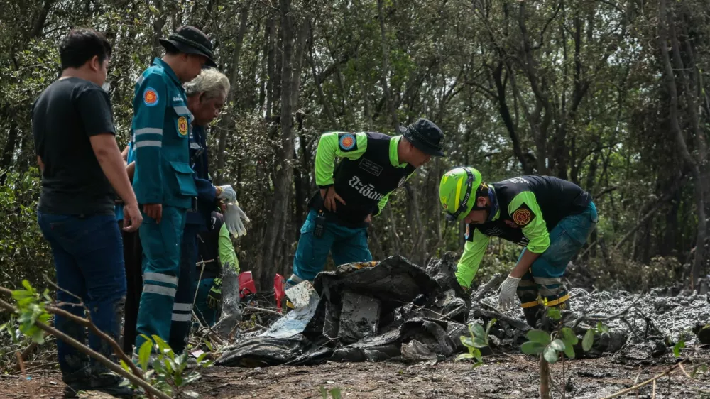 Rescue workers search the wreckage of a small aircraft a day after it crashed as five tourists from China and four Thais, including the two pilots, all presumed dead, in Bang Pakong, Chachoengsao province, Thailand, August 23, 2024. REUTERS/Patipat Janthong