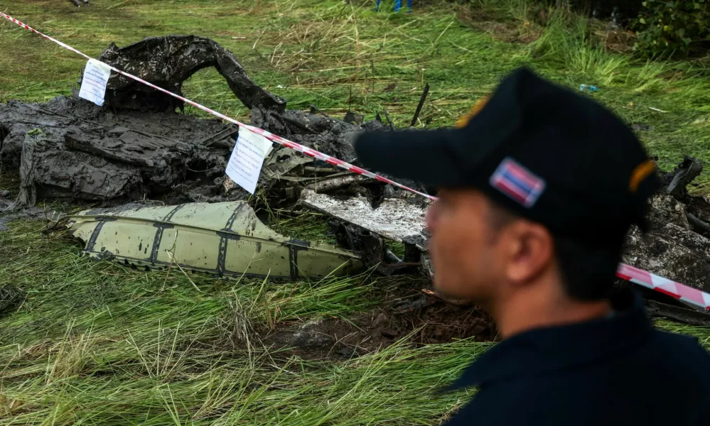 An official stands next to the wreckage of a small aircraft a day after it crashed as five tourists from China and four Thais, including the two pilots, all presumed dead, in Bang Pakong, Chachoengsao province, Thailand, August 23, 2024. REUTERS/Patipat Janthong