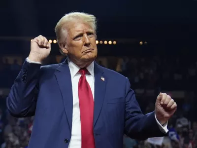 Republican presidential nominee former President Donald Trump dances at a campaign rally at the Desert Diamond Arena, Friday, Aug. 23, 2024, in Glendale, Ariz. (AP Photo/Evan Vucci)