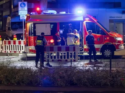 Emergency services and police are deployed near the scene where people were killed and injured in an attack at a festival in Solingen, western Germany, the German dpa news agency reported, Friday, Aug. 23, 2024. (Gianni Gattus/dpa via AP)