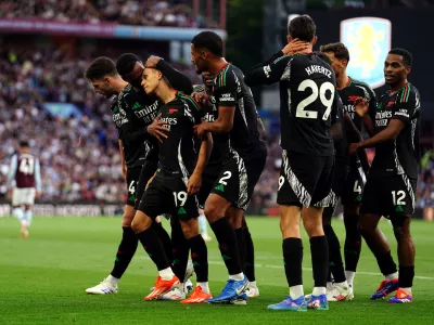 24 August 2024, United Kingdom, Birmingham: Arsenal's Leandro Trossard (3rd L) celebrates scoring his side's first goal with teammates during the English Premier League soccer match between Aston Villa and Arsenal at Villa Park. Photo: David Davies/PA Wire/dpa