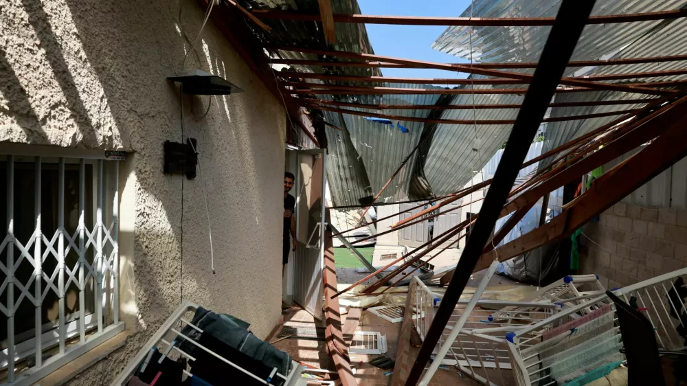 A view of a damaged residential building, after Hezbollah launched hundreds of rockets and drones towards Israel in what the Iranian-backed movement said was a response to the assassination of a senior commander in Beirut last month, in Acre, northern Israel August 25, 2024. REUTERS/Ammar Awad