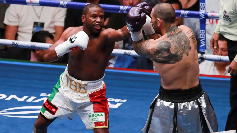 Floyd Mayweather Jr. and John Gotti III in action during their exhibition match, at the Arena CDMX, in Mexico City, Mexico, August 24, 2024. REUTERS/Henry Romero