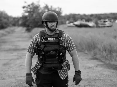 Reuters safety advisor Ryan Evans stands in a field while working with a news reporting team in an undated photo taken in Ukraine. REUTERS/Staff REFILE - QUALITY REPEAT