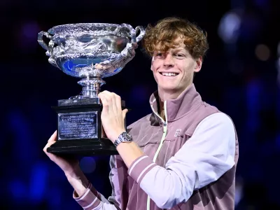 Jannik Sinner of Italy poses for photographs with the Norman Brookes Challenge Cup following his win in the Men's Singles final against Daniil Medvedev of Russia on Rod Laver Arena on Day 15 of the 2024 Australian Open at Melbourne Park in Melbourne, Sunday, January 28, 2024. (AAP Image/Joel Carrett) NO ARCHIVING, EDITORIAL USE ONLY