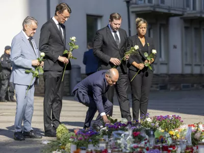 From left, Herbert Reul, Minister of the Interior of North Rhine-Westphalia, Hendrik Wüst, Minister President of North Rhine-Westphalia, German Chancellor Olaf Scholz, Tim Kurzbach, Mayor of Solingen, and Mona Neubaur, Deputy Minister President of North Rhine-Westphalia lay flowers, near the scene of a knife attack, in Solingen, Germany, Monday, Aug. 26, 2024. (Thomas Banneyer/dpa via AP)