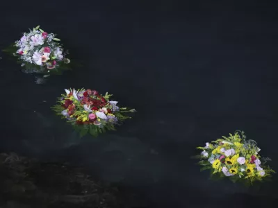 Flowers were sent out to sea as a tribute as Don Vincenzo the parish priest of Porticello in the municipality of Santa Flavia, celebrated mass for the victims of the Bayesian shipwreck in Porticello, Italy, Sunday, Aug. 25, 2024. (Alberto Lo Bianco/LaPresse via AP)