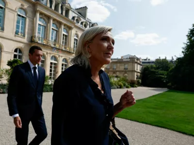 French far-right leader Marine Le Pen, member of parliament for the Rassemblement National (National Rally - RN) party and Jordan Bardella, President of the French far-right Rassemblement National (National Rally - RN) party, walk outside the Elysee Palace on the day of their meeting with French President Emmanuel Macron to discuss appointing a new prime minister, in Paris, France, August 26, 2024. REUTERS/Gonzalo Fuentes