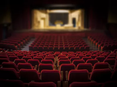 Empty red armchairs of a theater ready for a show