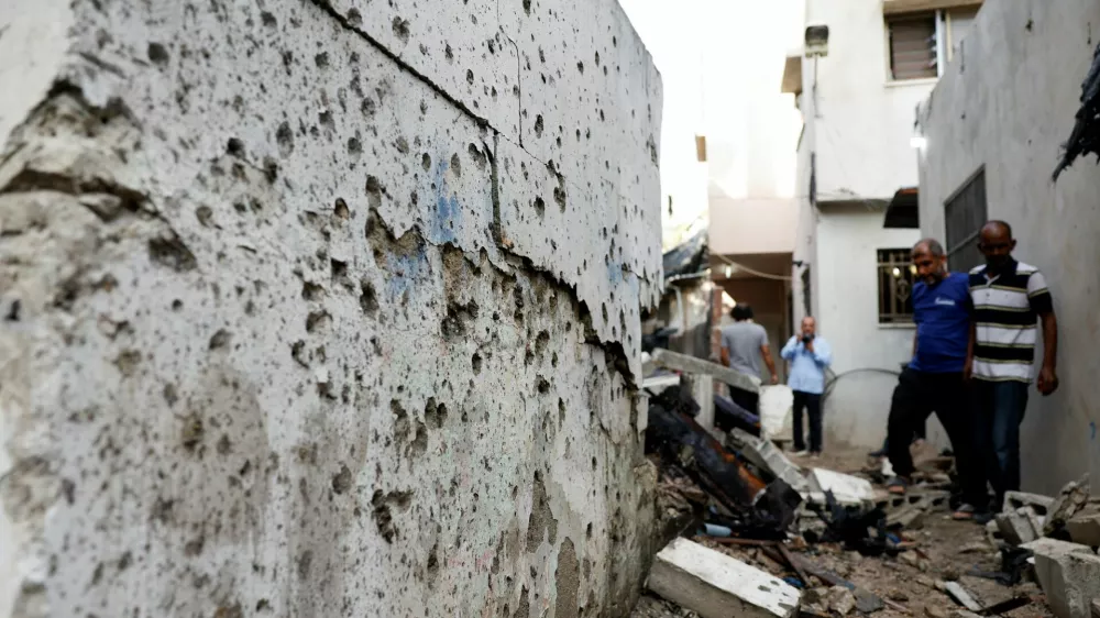 Palestinians assess damage at the site of a drone strike in Nur Shams refugee camp in Tulkarm in the Israeli-occupied West Bank, August 27, 2024. REUTERS/Mohammed Torokman