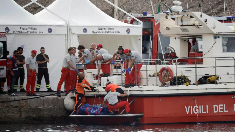 FILE PHOTO: Rescue personnel work next to the body bag containing the corpse of British entrepreneur Mike Lynch, who died when a yacht owned by his family sank off the coast of Porticello, near the Sicilian city of Palermo, Italy, August 22, 2024. REUTERS/Louiza Vradi/File Photo