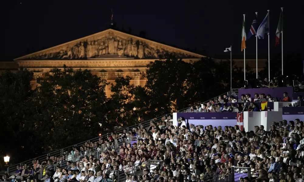 Spectators watch the Opening Ceremony for the 2024 Paralympics, Thursday, Aug. 29, 2024, in Paris, France. (AP Photo/Aurelien Morissard)