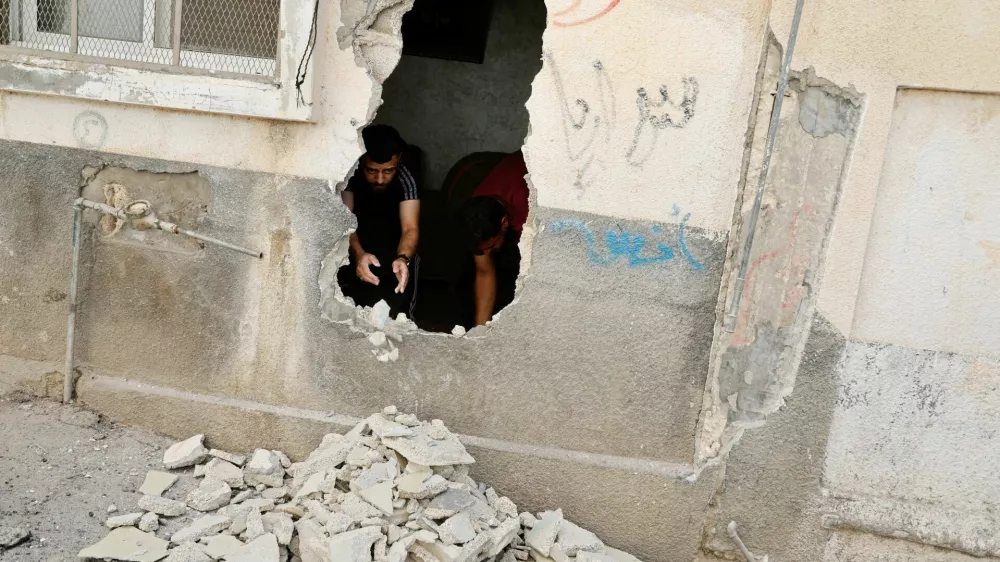 Palestinians inspect the damage, following an Israeli military raid in Al-Faraa camp, near Tubas, in the Israeli-occupied West Bank, August 29, 2024. REUTERS/Raneen Sawafta