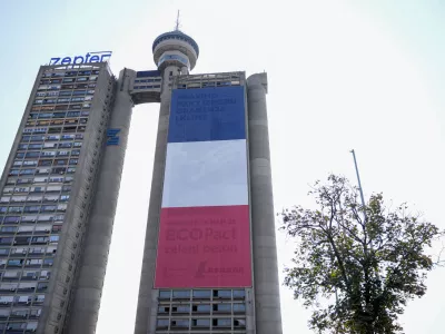 A giant French national flag on a skyscraper that is a symbolic gateway leading into the city from the airport, in Belgrade, Serbia, Thursday, Aug. 29, 2024. French President Emmanuel Macron starts a two-day state visit to Serbia on Thursday. (AP Photo/Darko Vojinovic)