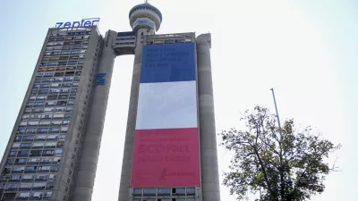 A giant French national flag on a skyscraper that is a symbolic gateway leading into the city from the airport, in Belgrade, Serbia, Thursday, Aug. 29, 2024. French President Emmanuel Macron starts a two-day state visit to Serbia on Thursday. (AP Photo/Darko Vojinovic)