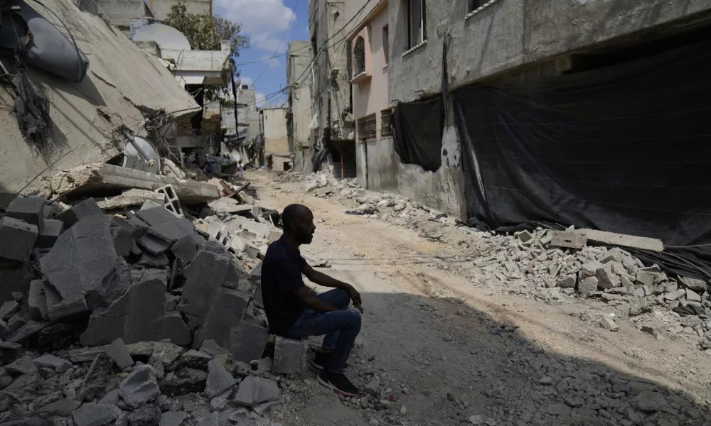 A Palestinian man inspects damaged houses following an Israeli military operation in the West Bank refugee camp of Nur Shams, Tulkarem Friday, Aug. 30, 2024. (AP Photo/Nasser Nasser)