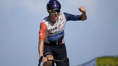 Canada's Michael Woods approaches the finish line to win the ninth stage of the Tour de France cycling race over 182.5 kilometers (113.5 miles) with start in Saint-Leonard-de-Noblat and finish in Puy de Dome, France, Sunday, July 9, 2023. (AP Photo/Daniel Cole)