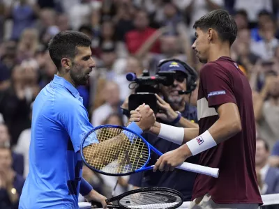 Novak Djokovic, of Serbia, shakes hands with Alexei Popyrin, of Australia, during a third round match of the U.S. Open tennis championships, Friday, Aug. 30, 2024, in New York. (AP Photo/Julia Nikhinson)