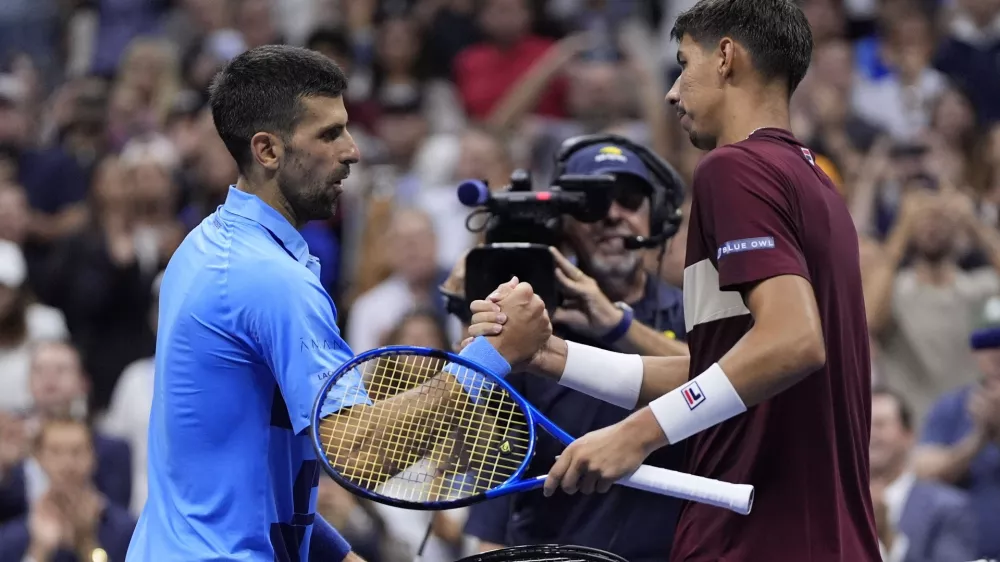 Novak Djokovic, of Serbia, shakes hands with Alexei Popyrin, of Australia, during a third round match of the U.S. Open tennis championships, Friday, Aug. 30, 2024, in New York. (AP Photo/Julia Nikhinson)